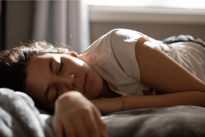 teenager sleeping on a bed