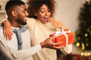 man giving a woman a Christmas gift